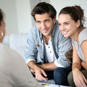 couple talking to approachable dentist