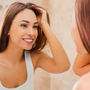 crooked teeth girl looking in mirror