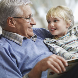 grandpa and granddaughter smiling at each other