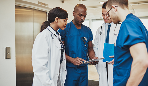 nurses gathering over clipboard