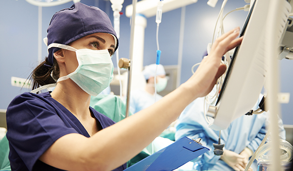 nurse at screen during surgery
