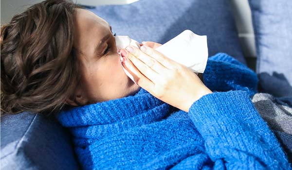 nurse blowing nose flu season carerev