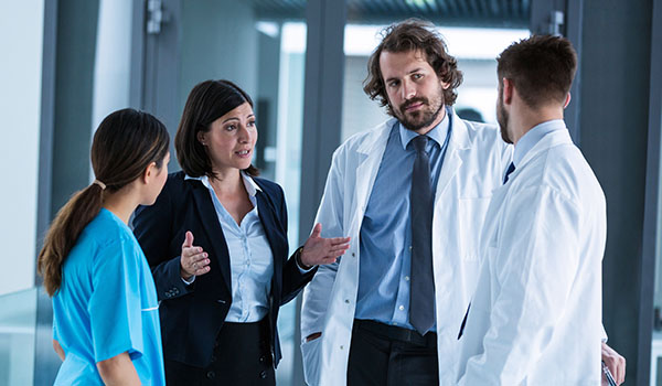 hospital administrator talking to medical staff