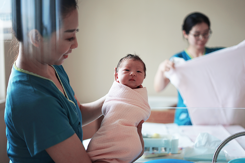 CareRe nurse holding a newborn baby in the labor and delivery unit