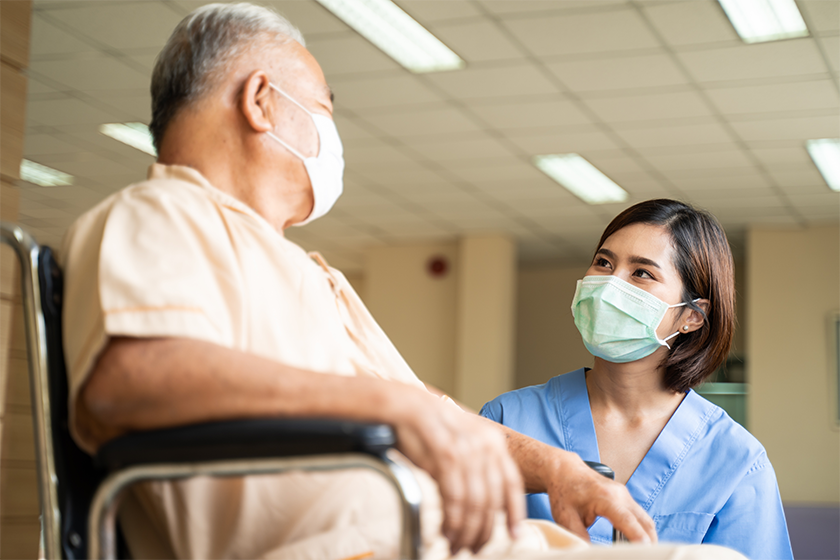 CareRev nurse talking to patient in a wheelchair
