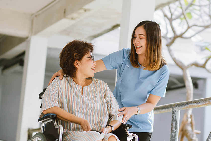 Local CareRev nurse helping a patient in a wheelchair