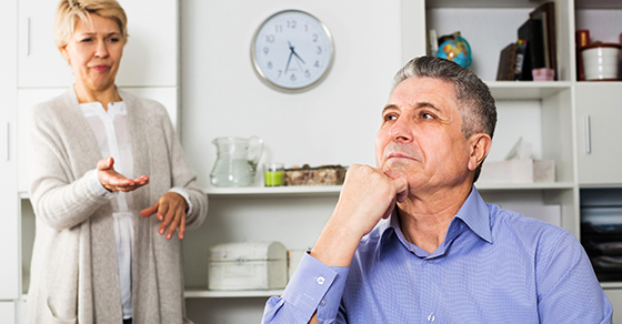 man looking off to the distance while woman gestures toward him