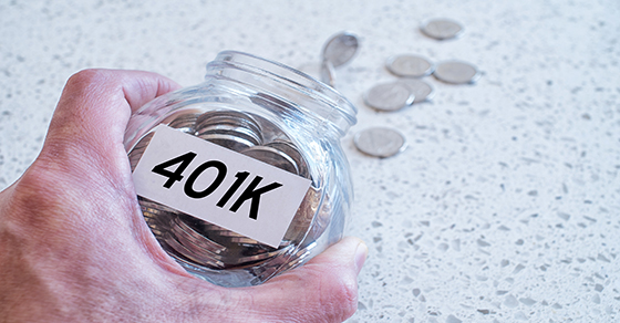 hand tipping coins out of jar labeled 401k