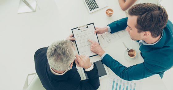 two men looking at paperwork
