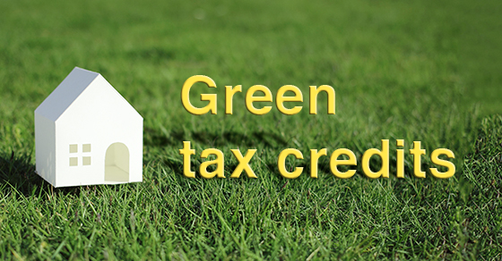 "green tax credits" letters on lawn next to small white house