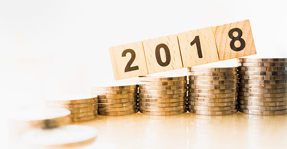 stacks of coins with blocks reading 2018