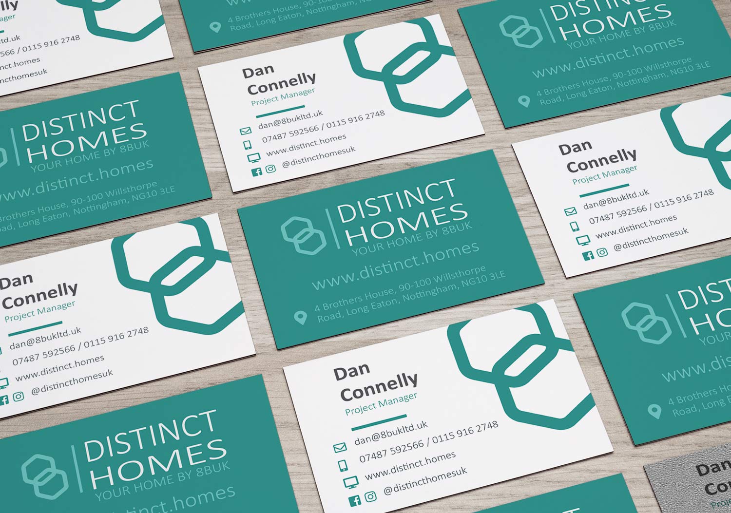 distinct homes business cards laid out on a table showing front and back as part of a branding exercise