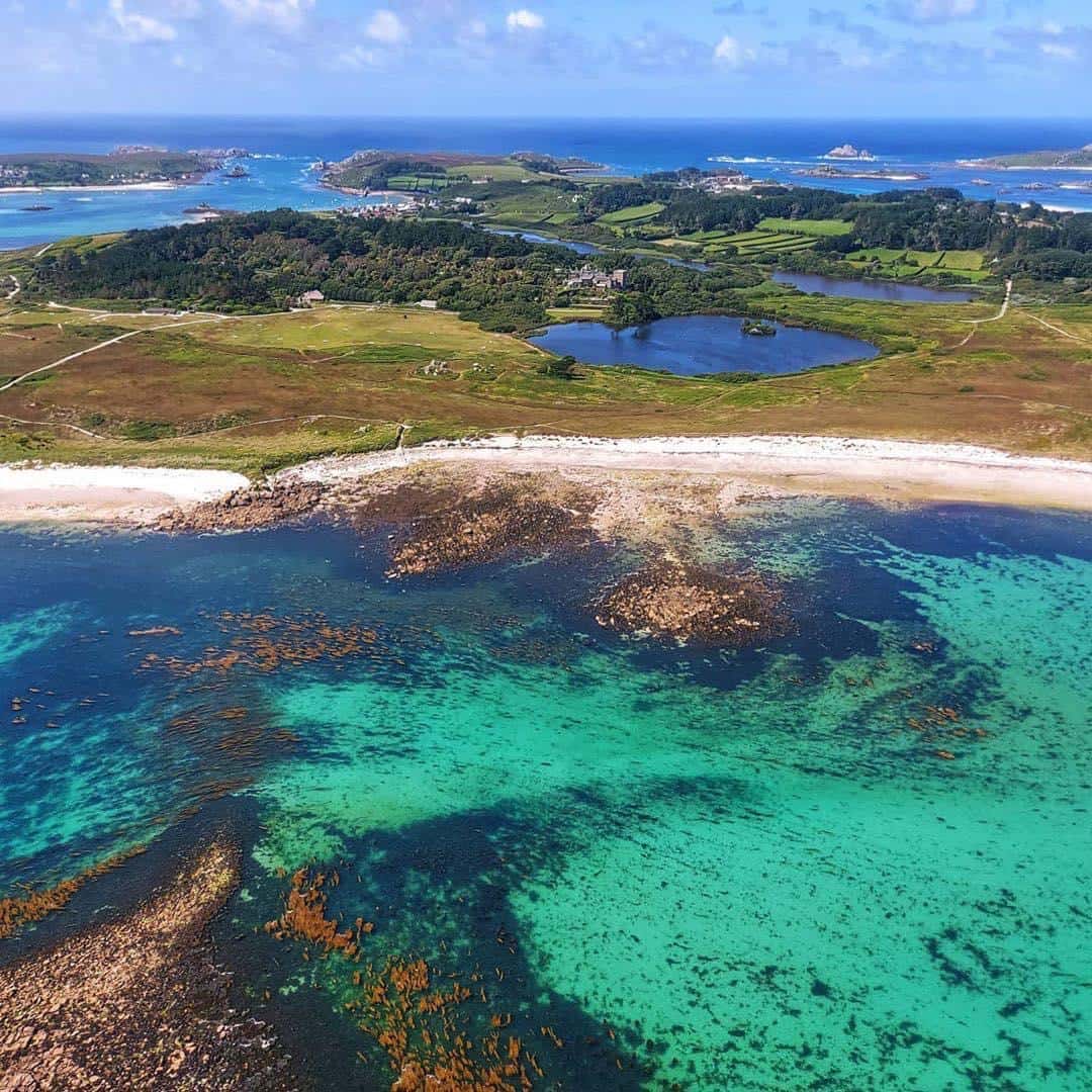 isles of scilly taken from above with turqoise waters on sunny day