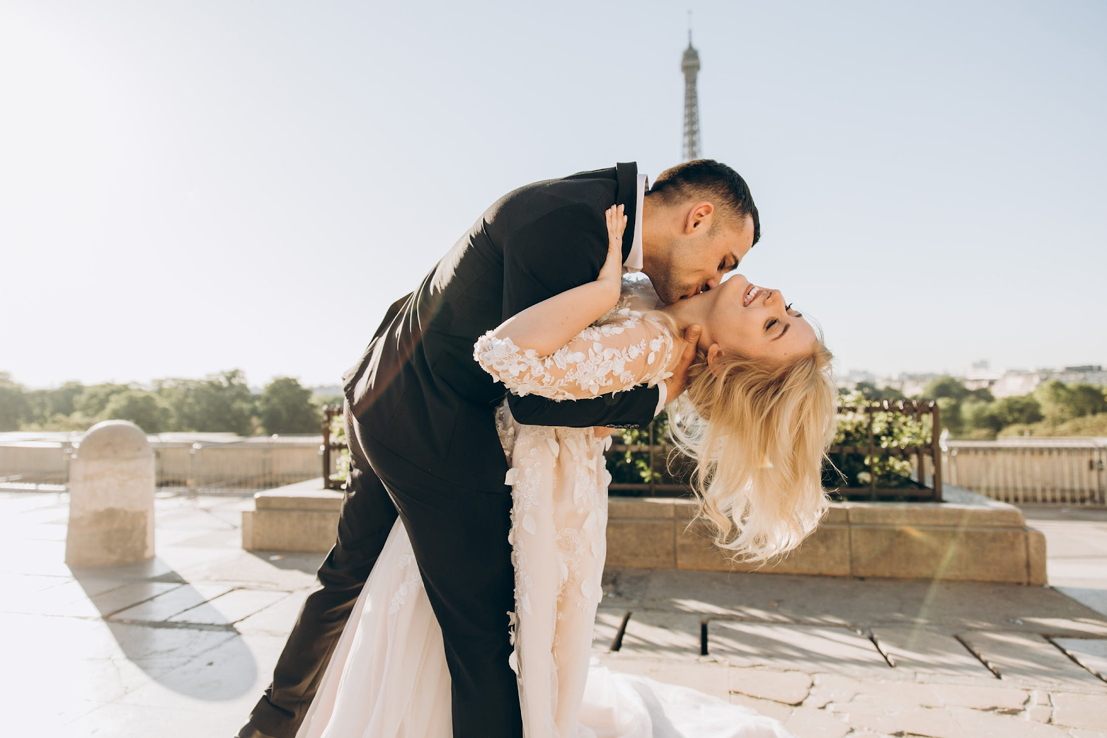 white bride and groom posing outside