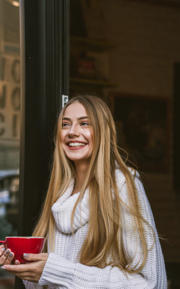 smiling woman holding coffee
