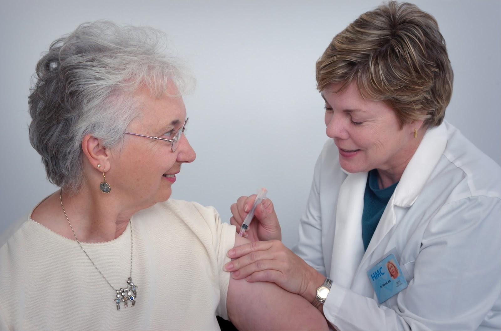 female physician giving patient a shot