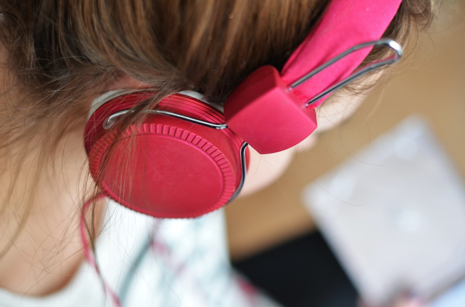 female wearing set of red headphones