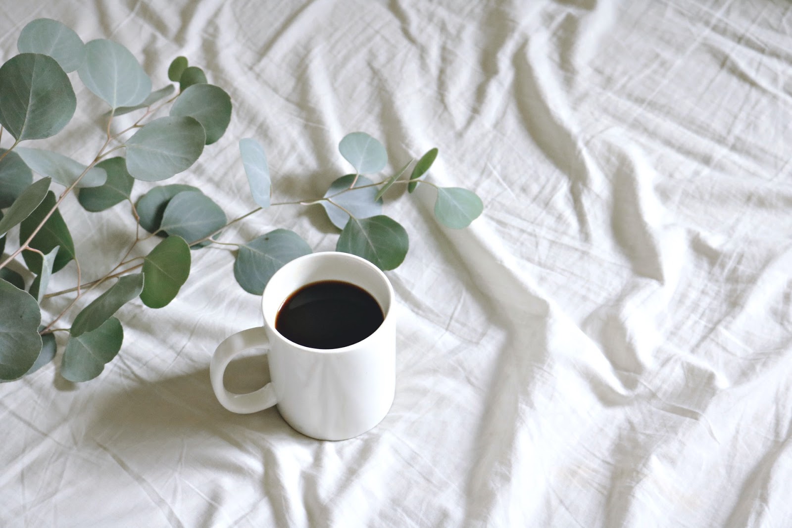 cup of coffee on bed
