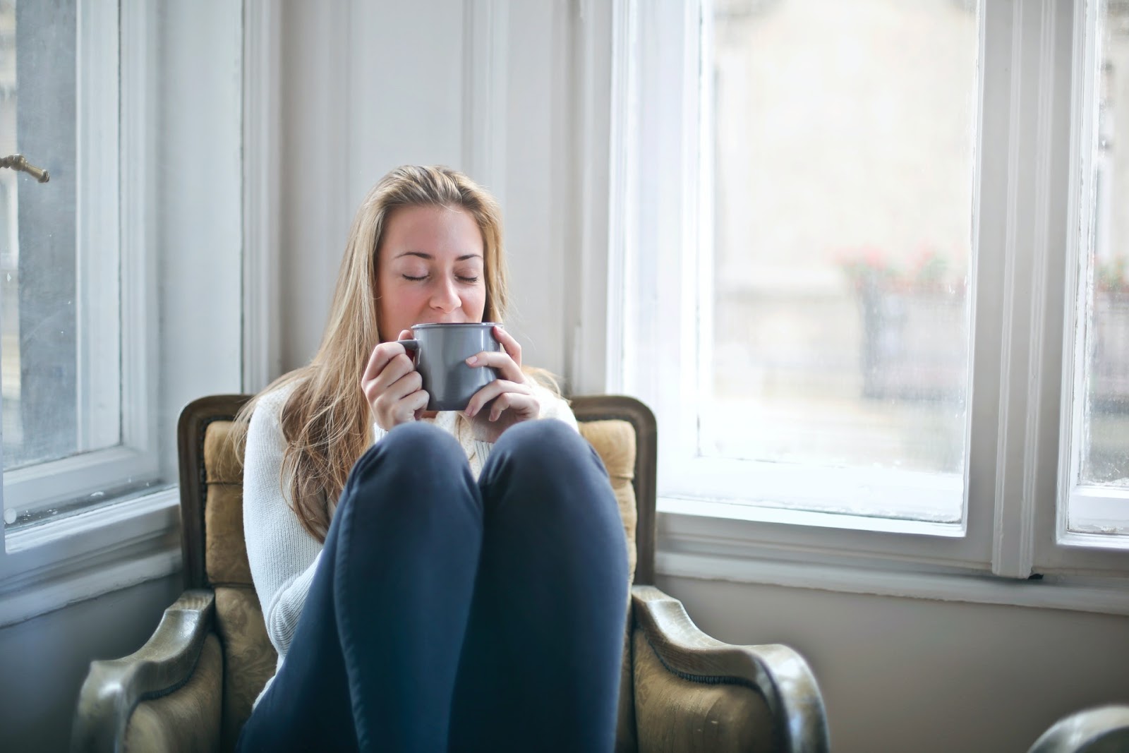 woman sipping on cup of tea