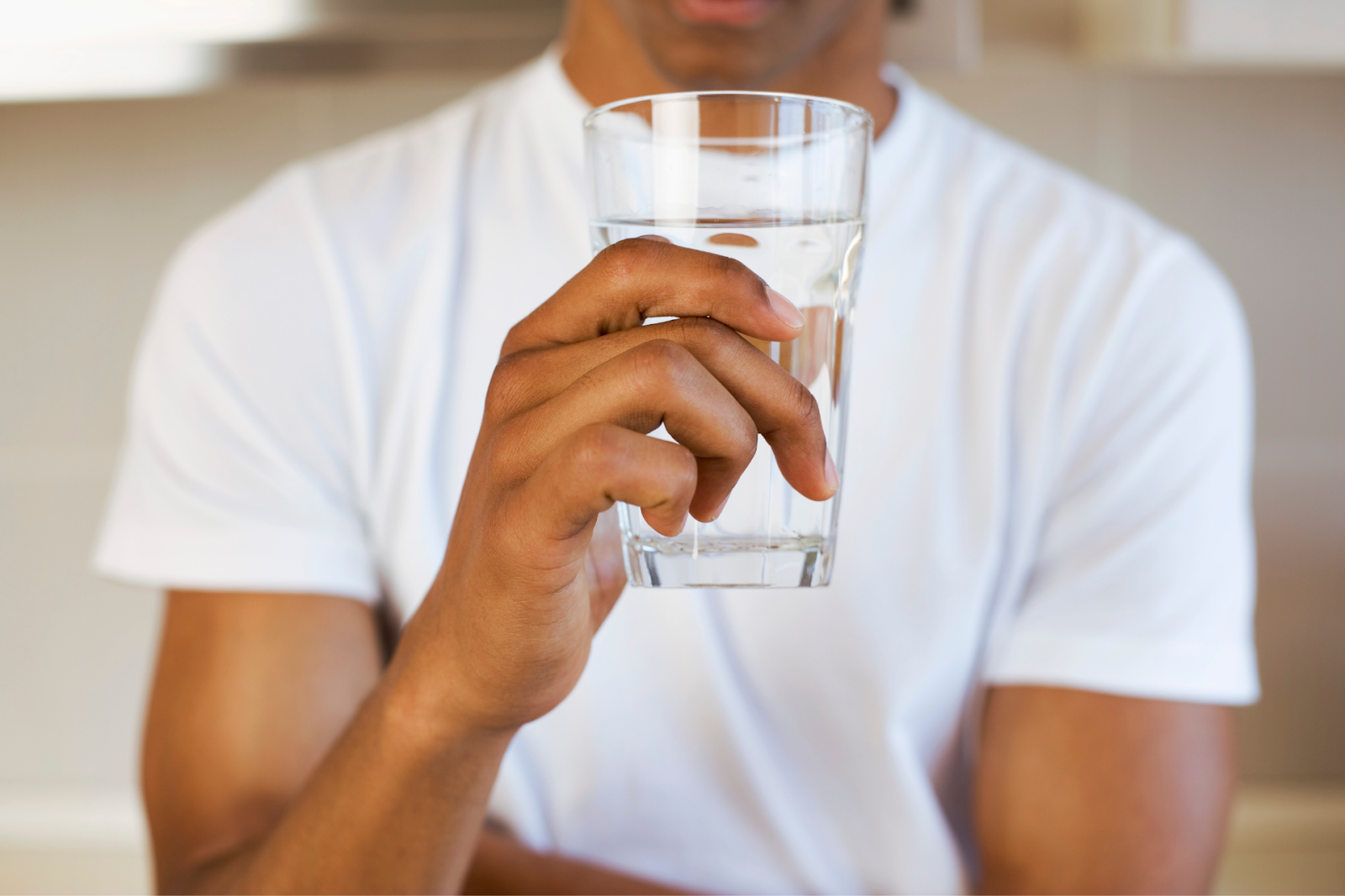 man drinking glass of water