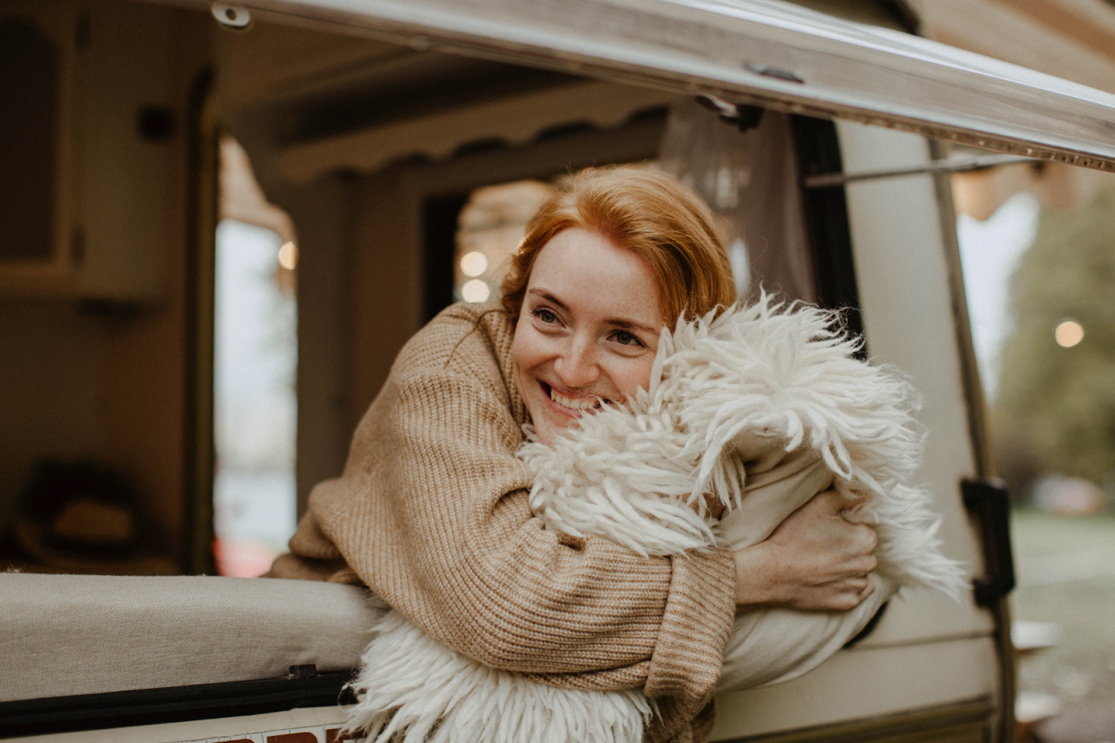 smiling woman holding pillow