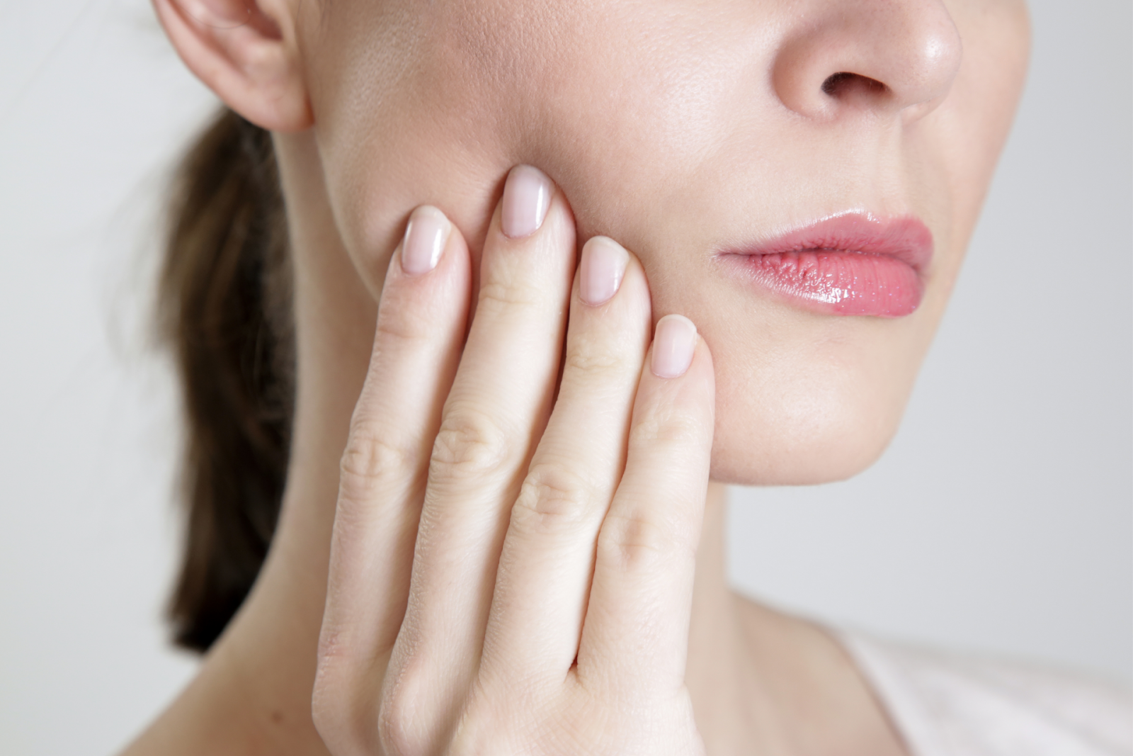 frowning woman touching face