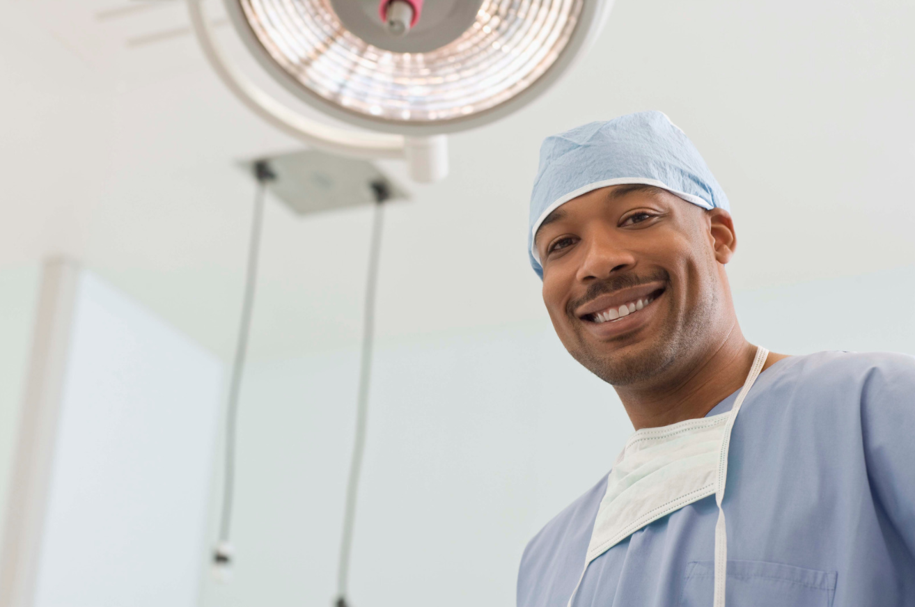 Surgeon in the operating room smiling at camera
