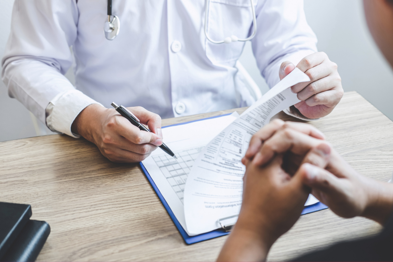 Doctor signing medical papers
