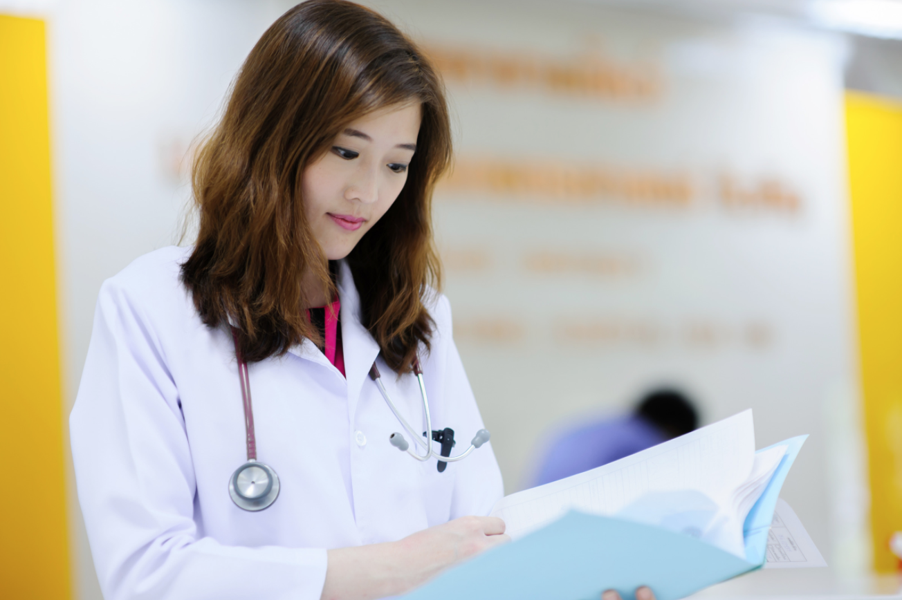 doctor looking through paperwork