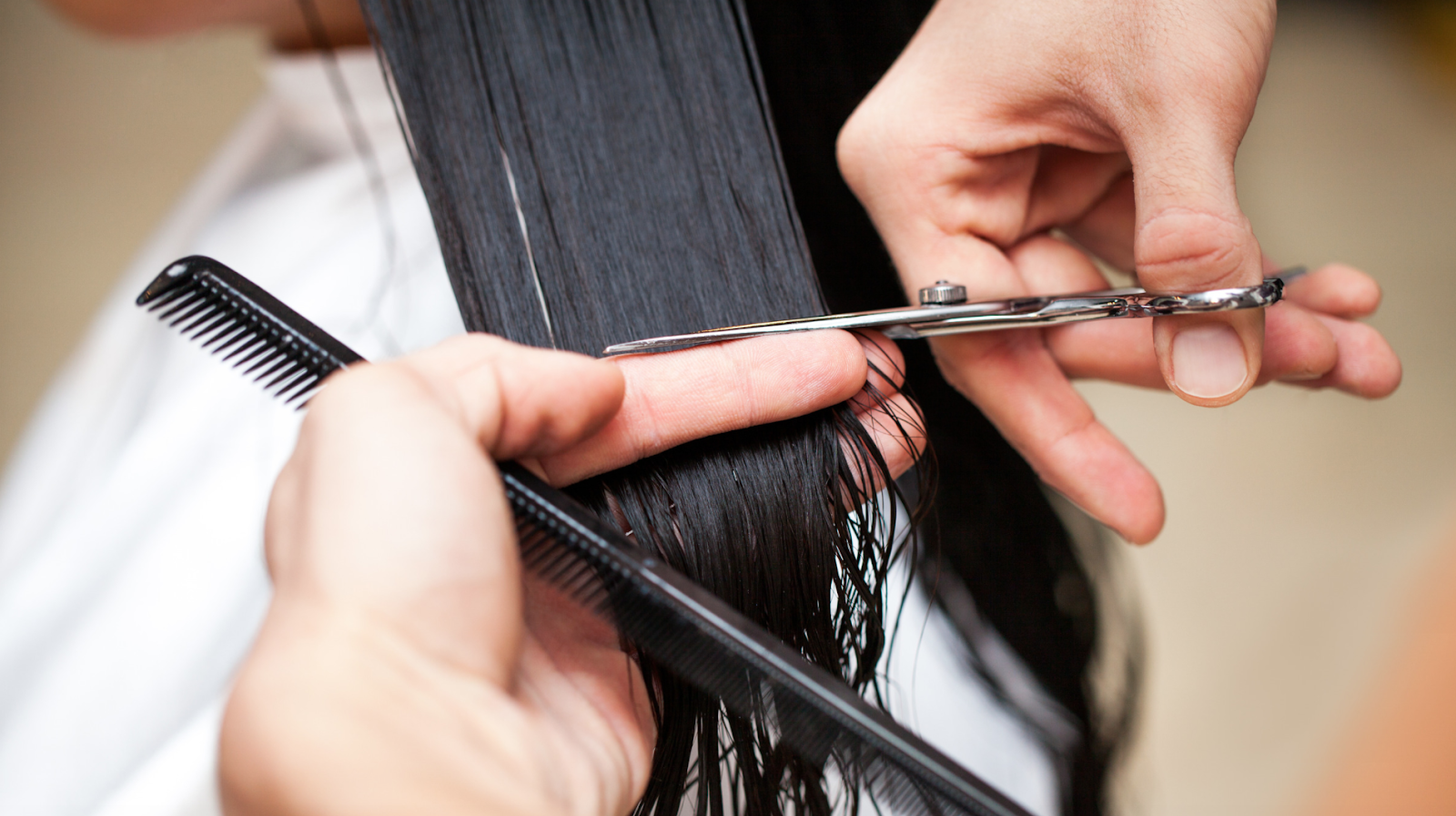 Closeup of long hair being cut