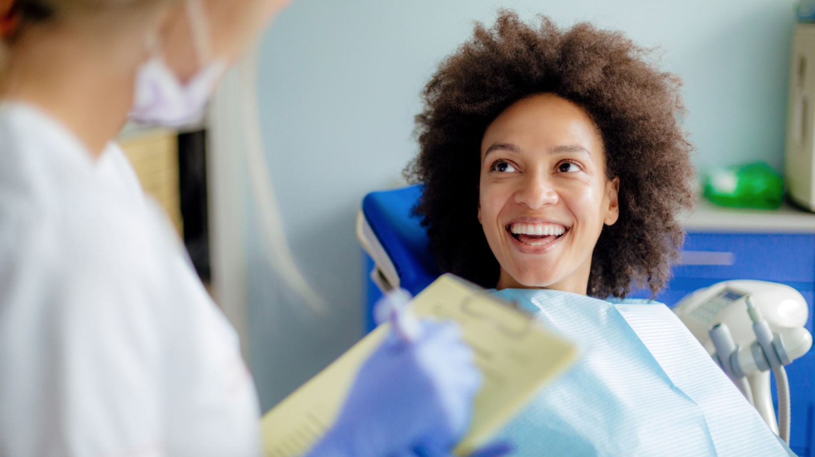 Women in dentists chair smiling