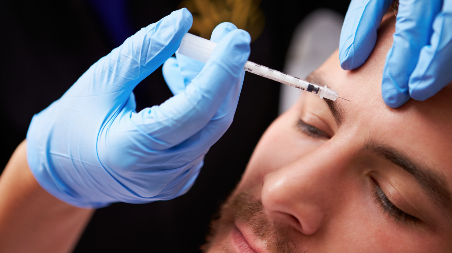 man getting Botox injection in eyebrow