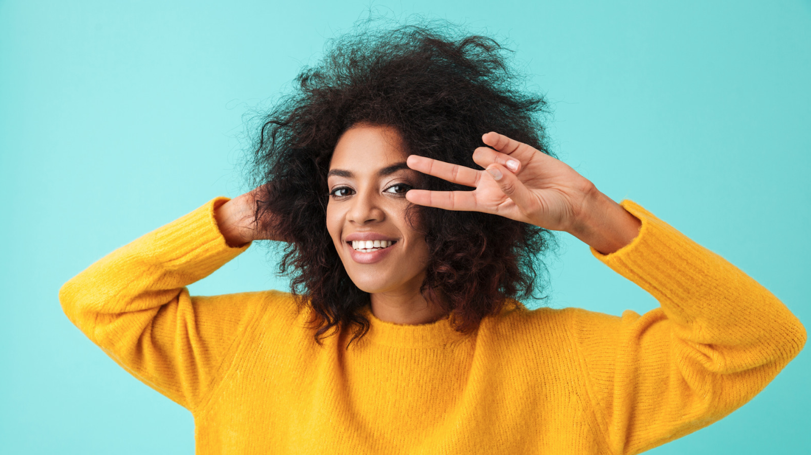 woman smiling and posing with a peace sign