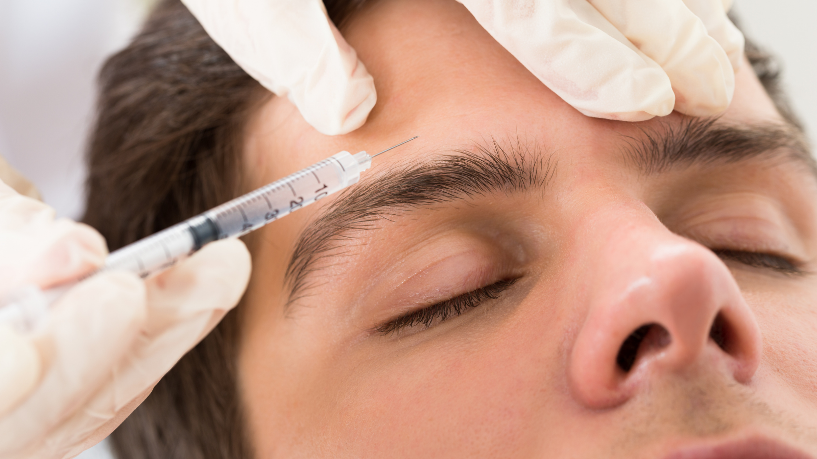 man getting Botox in eyebrow
