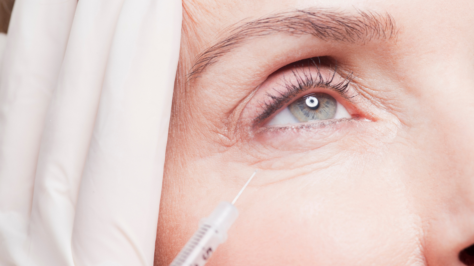woman getting Botox to fix wrinkles under eyes