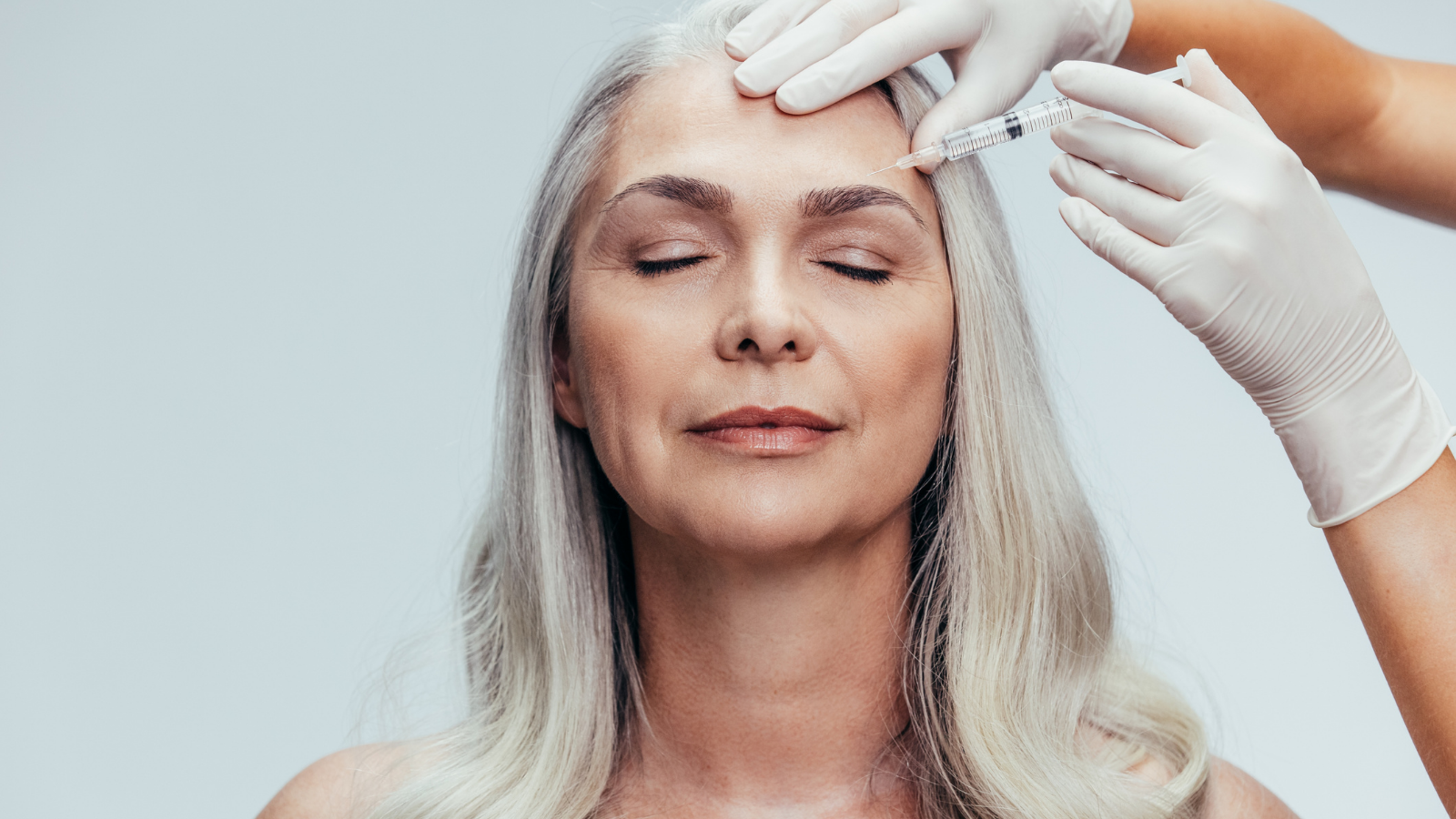 older woman getting Botox in eyebrow