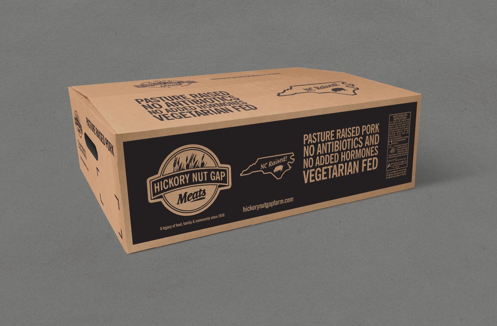 Hickory Nut Gap Meats Pork packaging/shipping cardboard box with black ink. Shown on gray background.