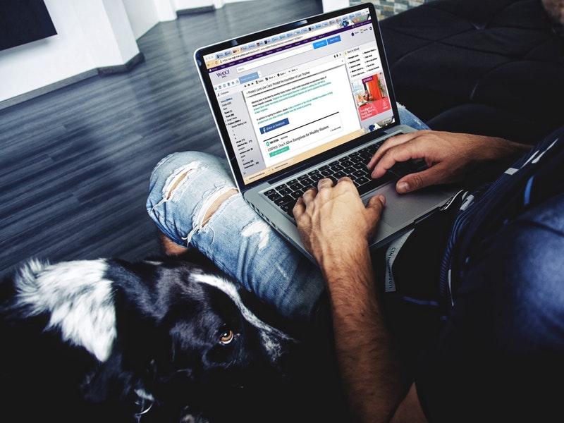 A man drafts an email on his computer.