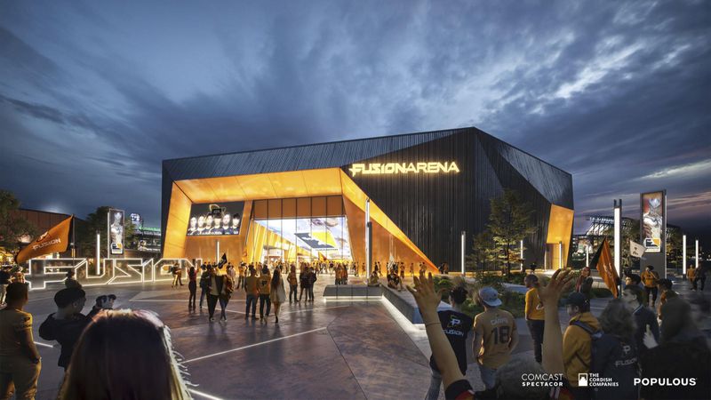 People stand outside a Fusion Arena, a black and yellow building.