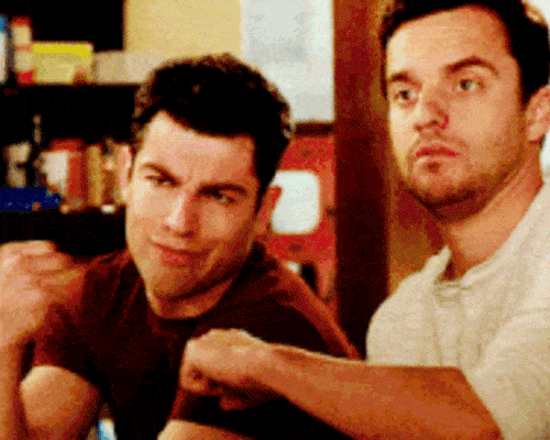 A gif of two characters from the tv show "The New Girl" doing a fistbump.