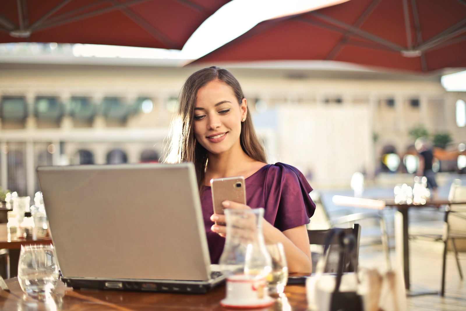 Woman phone laptop resturant
