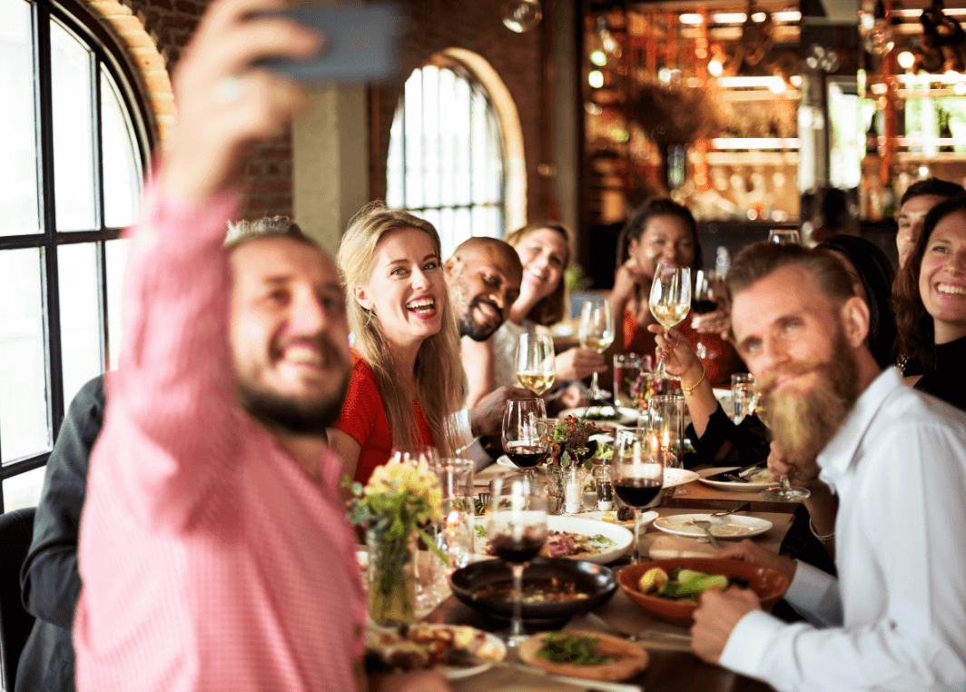 people at a restaurant taking a selfie