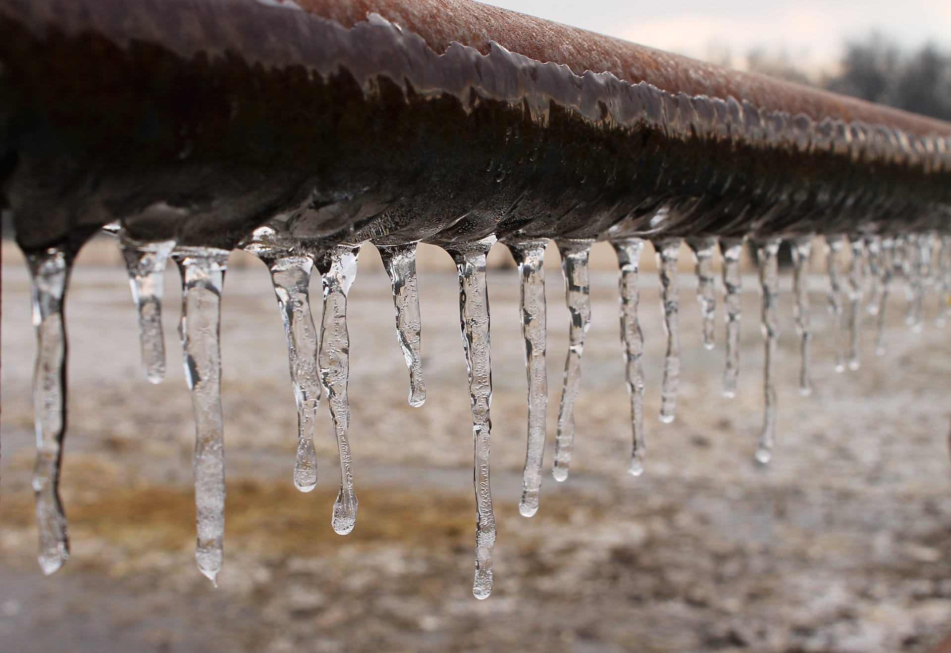 Pipe with frozen water hanging on it