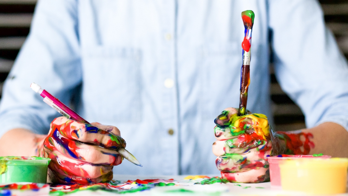 Kid with paint all over his hands