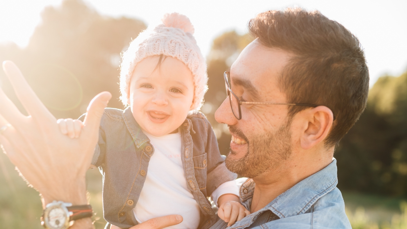 Dad giving his baby a high five