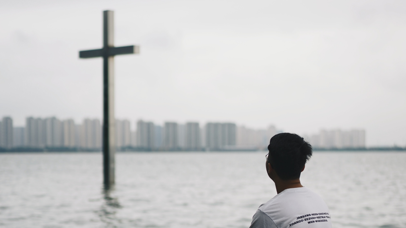 Guy looking at the cross