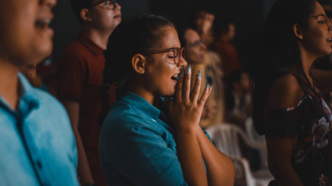 Girl singing in church and praying in her heart