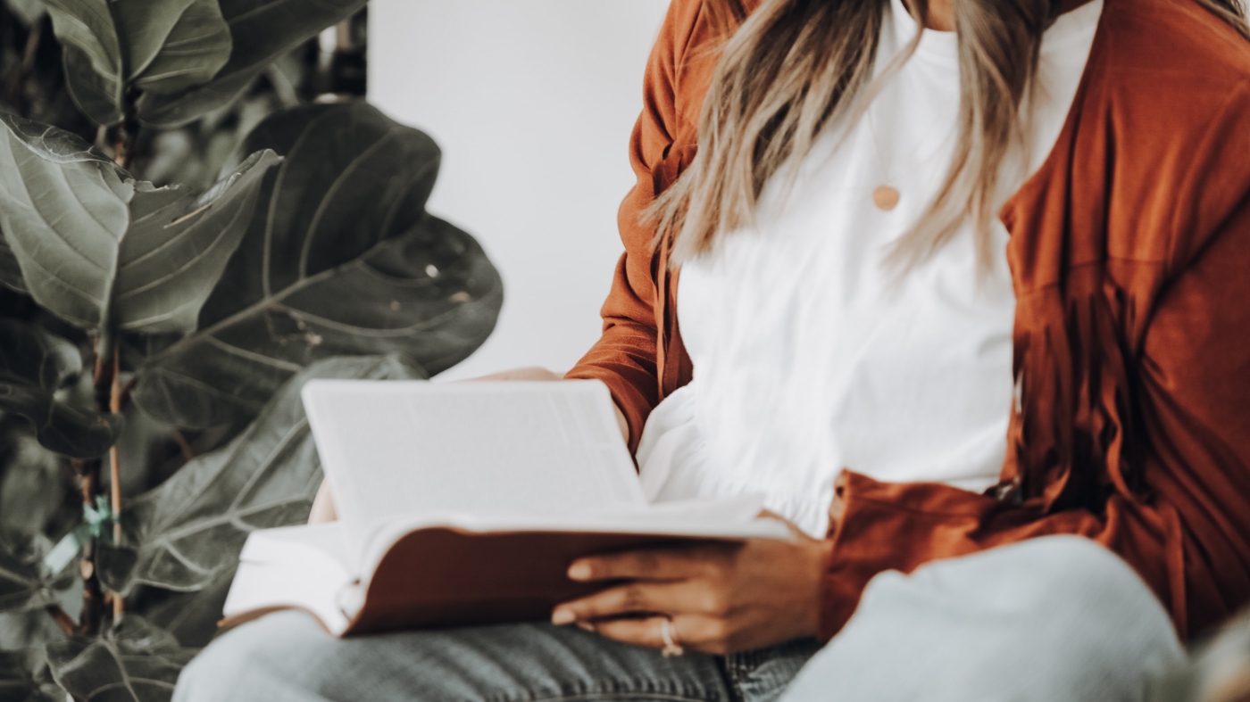 Woman reading bible in times of doubt