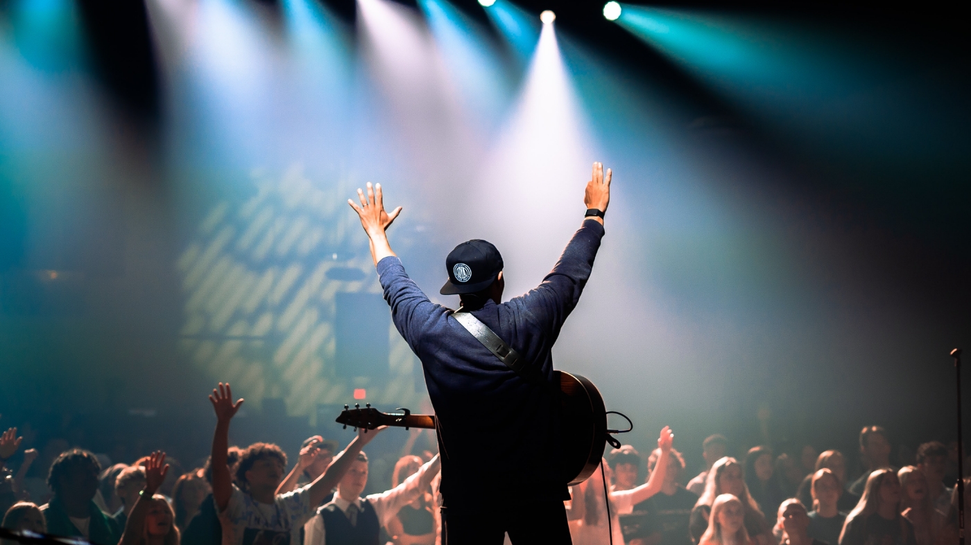 Teen at church leading song service