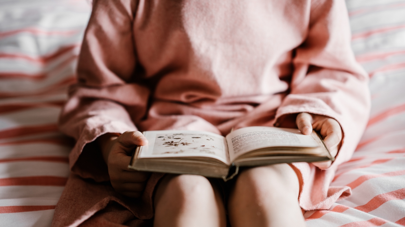 Young girl learns how to read